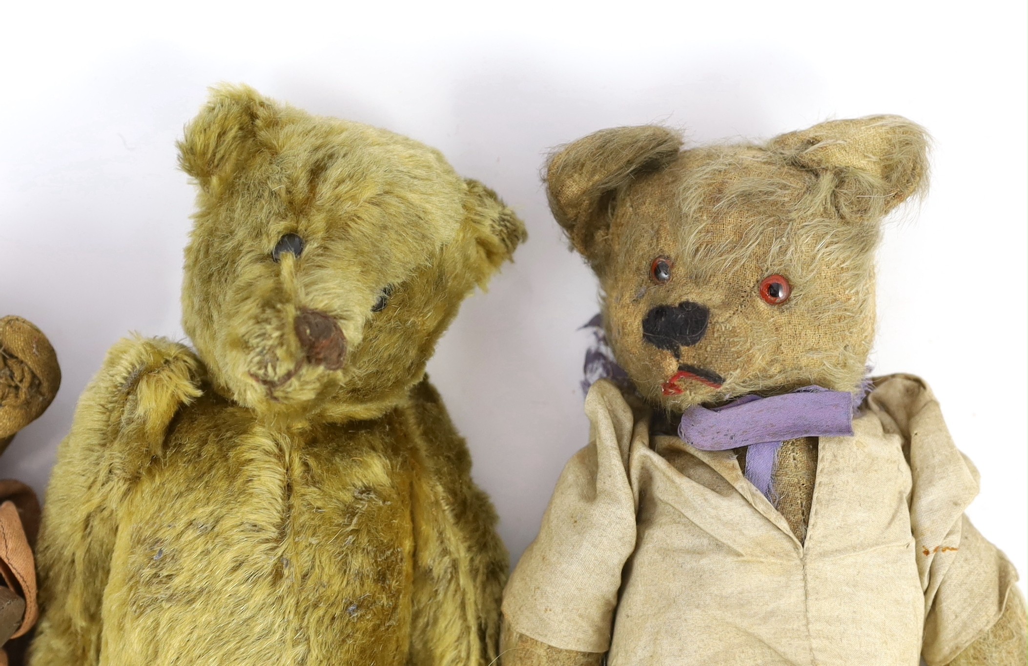 An early 20th century German Teddy bear, mohair plush and boot-button eyes, 12in., and two other Teddy bears